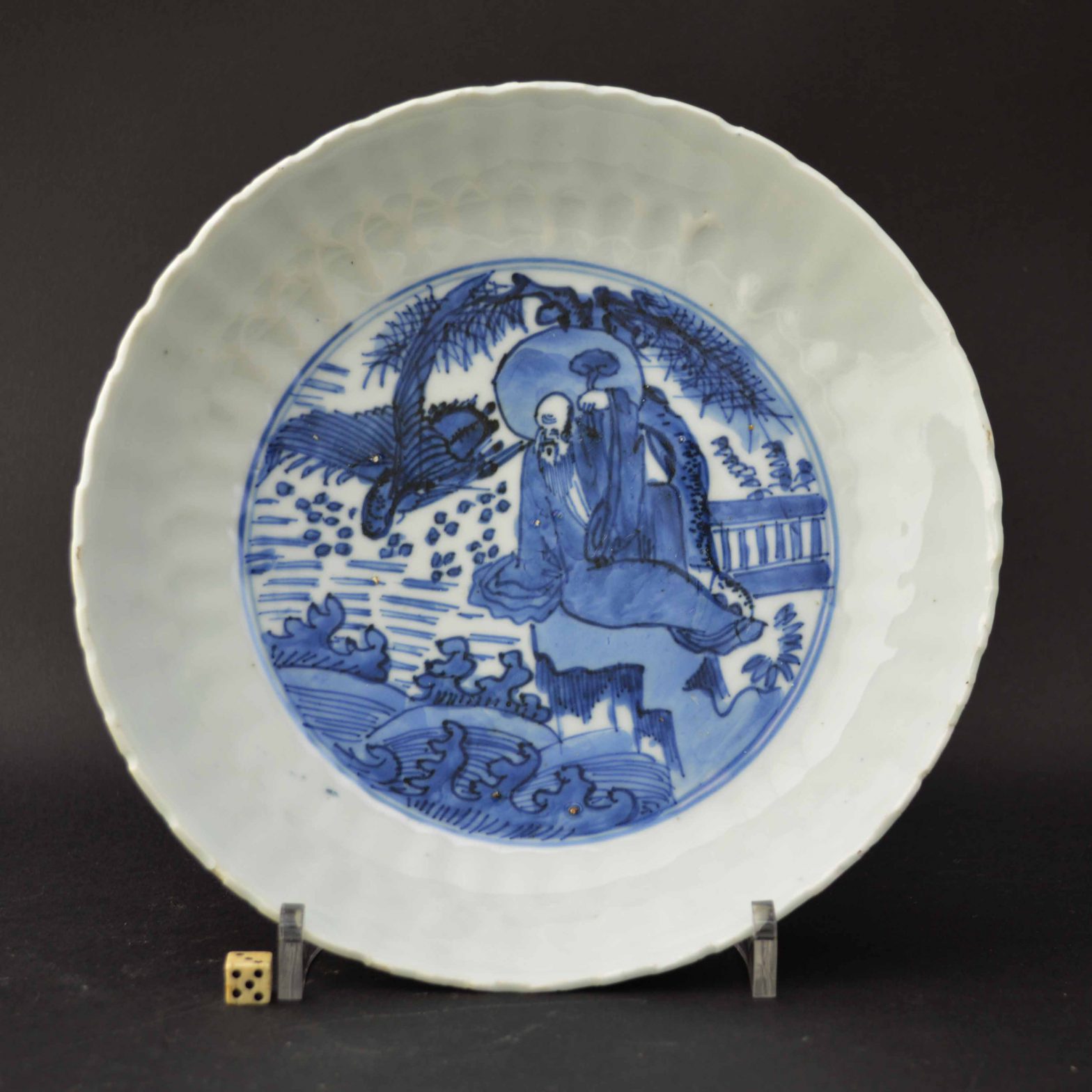 A Ming Porcelain Dish, Transitional, Tianqi 1621 - 1627, Depicting Shouloa in a Landscape -