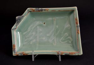 A Rare 17th Century Moulded Japanese Silver, Iron Red and Gold Decorated Celadon Dish, Arita Kilns c.1650-1670. The Rectangular Dish with a `Folded` Corner has a Moulded Three Character Inscription in Cursive Script to the Center.