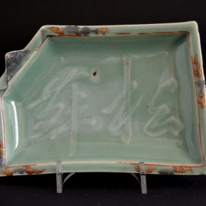 A Rare 17th Century Moulded Japanese Silver, Iron Red and Gold Decorated Celadon Dish, Arita Kilns c.1650-1670. The Rectangular Dish with a `Folded` Corner has a Moulded Three Character Inscription in Cursive Script to the Center. 