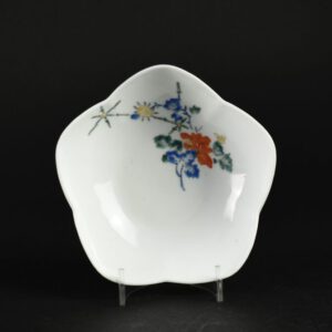 A 17th Century Japanese Kakiemon Porcelain Bowl. The shallow flower form has everted ‘petals’, it is painted using Kakiemon enamels with peony and bamboo trellis alluding to a garden scene. This understated subtle asymmetrical design is typically Japanese and is at its best on Kakiemon wares. The use of space shows off the pure white Nigoshide (milky white) body to its full effect.SOLD Condition In perfect condition, some minute firing spects to the glaze. Size Diameter 12.2 cm (4 3/4 inches) Provenance From a Private English Collection. Stock number 26068