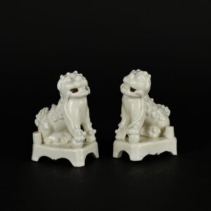 A Pair of Late Ming Dynasty or Early Qing Dynasty Blanc de Chine Porcelain Fu Dogs or Buddhist Lions, Dehua Kilns, Fujian Province. Chongzhen Period to Shunzhi c.1630 – 1660. These are early models with cut bases and teeth, the glaze is tinged with a feint rose colour. Compare to two pairs of Blanc de Chine Fu Dogs below, one of which is earlier and the other pair later.