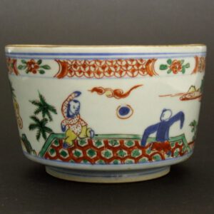 An Unusual Late Ming or Early Qing Porcelain Wucai Container for the Japanese Market, Probably a Hiire. Late Chongzhen Period 1628 – 1644 or Shunzhi 1644-1661 Period. Decorated with Boys at Play in a Garden Landscape. Two Boys Play with a `Football` on a Brightly Coloured Rug and Another Boy Lights a Firework While Another Watches. The Interior of the Object is Unglazed Apart From an Area Below the Rim.SOLD Condition A large firing crack that has extended crack. The body of the piece is slightly misshapen where the firing crack is. Size Diameter : 14 cm (5 1/2 inches) Provenance N/A Stock number 21865-1