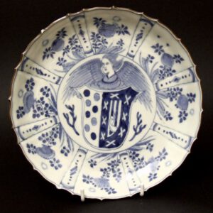 A Rare 18th Century Japanese Blue and White Porcelain Dish. The Center Decorated with a Rather Wild Looking Angel Holding a Shield with an Armorial Device. The Border of this Shaped Barbed Rim Dish is Decorated in the Kraak Porcelain Style
