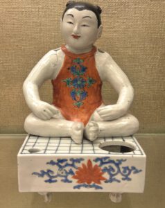 A Rare Kakiemon Figure of a Boy on ‘Go’ Board, Late 17th Century. On display at the Fitzwilliam Museum, Cambridge.