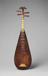 More details Pipa (琵琶) Chordophone-lute-plucked-fretted The spectacular back and sides of this unique Ming-dynasty instrument feature more than 110 hexagonal ivory plaques, with thinner bone plaques on the neck. Each plaque is carved with Taoist, Confucian, or Buddhist figures and symbols signifying prosperity, happiness, and good luck. These include images of various gods and immortals, such as Shou Lao, the Daoist god of longevity, who is shown with a prominent forehead on the single plaque at the very top. When the instrument is played, this expert workmanship remains unseen by the listener, as the back faces the player. The front is relatively plain but shows signs of use. The ivory string holder bears a scene featuring four figures and a bridge; an archaic cursive inscription; and, at the lip, a bat motif with leafy tendrils. 