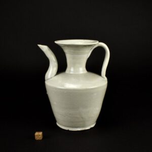A Song Qingbai wine ewer, 12th to mid-13th century, probably from a kiln in Fujian province. This thickly potted Song dynasty porcelain ewer would originally have had a warming bowl with it, these were close fitting but would have enabled warm water to keep the wine at the right temperature. The earliest known qingbai wares were produced in Jingdezhen in Jiangxi province around the late 10th century and are characterized by faint pale-blue glazes on low, wide forms. Qingbai continued to be enormously popular and highly produced throughout the Song dynasty (960-1279) and was prevalent in the Yuan dynasty (1279-1368), but slackened during the Ming dynasty (1368-1644) until being replaced by tianbai, ‘sweet white’ ware. The initial forms of qingbai were simple bowls and dishes, but by the mid-Northern Song the forms had advanced to include a wide variety of objects used for daily life such as ewers, boxes, incense burners, granary models, vases, jars, sculptures, cups, cupstands, water droppers, lamps, grave wares, and tools for writing and painting. The precedent for the majority of these forms is found in earlier metalwork and lacquer and Rawson has suggested that the imitation of silver was the primary force behind the production of white wares, including qingbai.See Below For More Photographs and References. SOLD Condition Good, a shallow glaze chip to the end of the spout and three chips to outer edge of the base . Size Height : 17.8cm (7 1/2 inches). Provenance A Private Collection of Early Chinese Ceramics in London. Stock number 24938