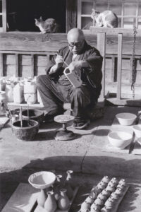 Shoji Hamada 1894 - 1978, painting a Sugar Cane vase.