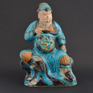 A Ming Pottery Figure of Guandi, Jiajing (1522-1566), Longqing (1567-1572) or Wanli (1573-1620), Northern China. The Moulded Figure is Decorated in Rich Coloured Lead-Glazes with areas of Bare Pottery that would have been Cold-Painted.SOLD Condition n very good condition. The thin glaze has come away from the body in a few places, notably on the right side of Guandi below his raised leg. There are other smaller areas of glaze loss. Size Height : 28 cm (11 inches) Provenance N/A Stock number 24347 References For a Ming model of Buddha on his throne of the same type of pottery but a very different model and glaze colouring dated `Wanli, 12th Year (1584), 5th Month, Auspicious Day` see our `Sold Items` number 23133.