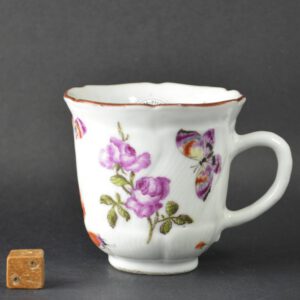 An 18th Century London decorated Chinese Export Porcelain coffee cup c.1750-1760, enamelled in London between c.1755-1765. The moulded Chinese Export Porcelain cup was painted in London, probably in the James Giles workshop. Painted with a large sprigs of English flowers, butterflies and further scattered flowers.SOLD Condition In excellent condition, there is a very small shallow chip to the footrim a nd a minute frit to the rim c.1 x 1mm. Size Height : 6.7 cm (2 2/3 inches) Provenance Robert McPherson Antiques 12th November 2007. The Helen Espir Collection of Over Decorated Chinese Porcelain. Stock number 24717