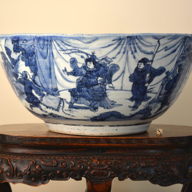 A very large rare Ming Kraak porcelain bowl, Chongzhen period 1628-1644. The exterior is not in the Kraak style but is more Chinese, with a scene taken from a popular Chinese legend or story with a warrior leader with a temporary loose material screen behind him and other figures as well as an extensive landscape. The interior of this deep bowl is typical of late Kraak ware with its panels of landscapes with figures and rather European looking buildings. The well of the bowl is decorated with a lady spooling silk, sometimes referred to as the ‘spinning’ design. This unusual domestic scene is found on a number of bowls of this type but was is rare about this bowl is the contrast between the Kraak interior and the ‘Transitional’ style of the exterior. The quality of painting, with it’s rather loose free brushwork, is reminiscent of Transitional porcelain made for the Japanese market. Indeed I think it is highly likely that many of the workshops in Jingdezhen produced Kraak ware as well as porcelain for the Japanese market. However the present example is very much in Dutch taste.SOLD Condition Four large sections from the rim restuck. Small chips filled. Size Width : 36 cm (14 inches) Provenance Amsterdam (Christie's or Sotheby's) R&G McPherson Antiques The Roy Davids Collection of Chinese Ceramics, Purchased June 1st 2002. Collection label to the base no. 140. Stock number 24605 References For three bowls in this late Kraak style that incorporate transitional porcelain elements see : Kraak Porcelain, A Moment in the History of Trade (Maura Rinaldi, Bamboo Publishing,1989) Pages 163 - 164 Plates 202 - 204. Plate 202 includes the 'spinner' design, but none have a continuous to the exterior. Dated c.1635-1650. For another large Kraakware bowl of this type with a 'spinning' scene to the well but again without the rare continuous scene to the interior see : Kraak Porcelain, The Rise of Global Trade in the Late 16th Century and Early 17th Century (Jorge Welsh Book, London. 2008. ISBN 0-9550992-9-3) page 314, plate 59. Dated 1628-1644. A further Ming porcelain bowl of this type is illustrated in : Chinese Porcelain in the Collection of the Rijksmuseum Amsterdam, The Ming and Qing Dynasties (Christiaan Jorg, Phillip Wilson, The Rijksmuseum, 1997) page 64, plate 48.