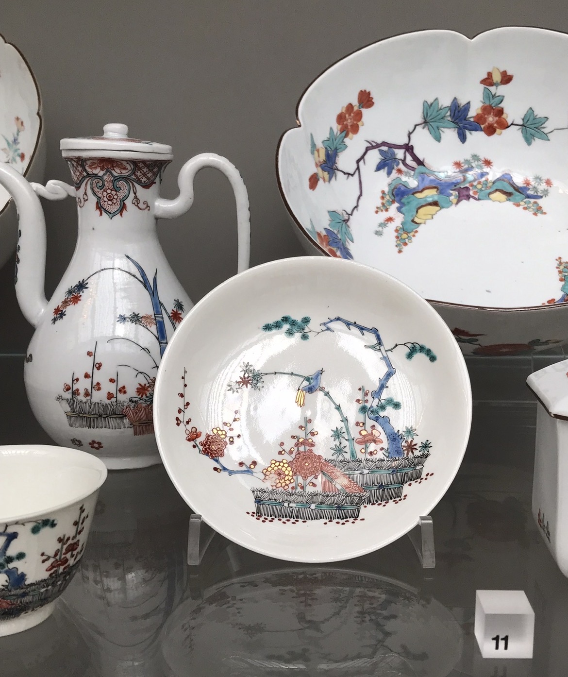Meissen porcelain painted in the Netherlands.The Rudolphe Lamaire Plot Meissen porcelain painted in the Netherlands... "may have been part of an infamous scheme to dupe wealthy clients into buying imitations of Japanese porcelains which were very expensive and only imported in small numbers. The plot centred on a French merchant named Lemaire who was spurred on by the demand for Kakiemon porcelain in Paris. He purchased undecorated Meissen porcelain from the factory warehouse in Dresden in 1728-29, and sent it to be decorated in Holland 'in the taste of old Japan'. He chose Dutch decorators as they were skilled at working on plain white Chinese porcelains and, of course, on their own homegrown earthenwares made in Delft. He arranged for the Meissen pieces he bought not to have the usual underglaze crossed sword marks applied to their bases, or to have the mark applied overglaze so that it could easily be ground off. Luckily the plot was discovered in 1731, by which time the Meissen factory was catering to the fashion for exotic porcelain by decorating its own wares with convincing Japanese designs, copied from authentic Japanese pieces in the Saxon royal collection." (From the Victoria & Albert Museum website).