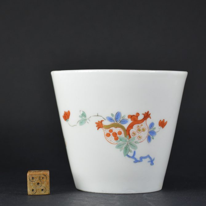 An 18th Century Meissen Porcelain Beaker in the Kakiemon Style from the Collection of Augustus the Strong. Decorated with sprigs of fruiting pomegranate exposing their seeds and a sprig of flowering peony. The base with an over-glaze Crossed Swords Mark in blue enamel for Meissen and a wheel engraved Johanneum Inventory mark N : 334 – W.SOLD Condition In poor condition ; a large dark crack 55 mm which then turns left for c.20 mm. A shallow chip to the outer rim c.5 x 5 mm. Size Size: Height 6.8 cm (2 3/4 inches) Provenance Augustus the Strong (1670 - 1733). The Royal Collection at The Japanese Palace, Dresden, Wheel Engraved Johanneum Inventory mark to the base N : 334 - W. Stock number 235721 References For a pair Meissen Kakiemon beakers and saucers of this design dated c.1725-1730 see : Kakiemon, Une Europe Sous L`Influence Du Japon A Travers La Porcelaine Aux 17eme Et 18eme Siecles Collections Privees (Vincent L`Herrou,Tomate & Risson, undated c.2006) see page 91. A fluted Kakiemon beaker of this design dated to 1729-1731 is in the Victoria and Albert Museum. Room 139, shelf 3, item 9