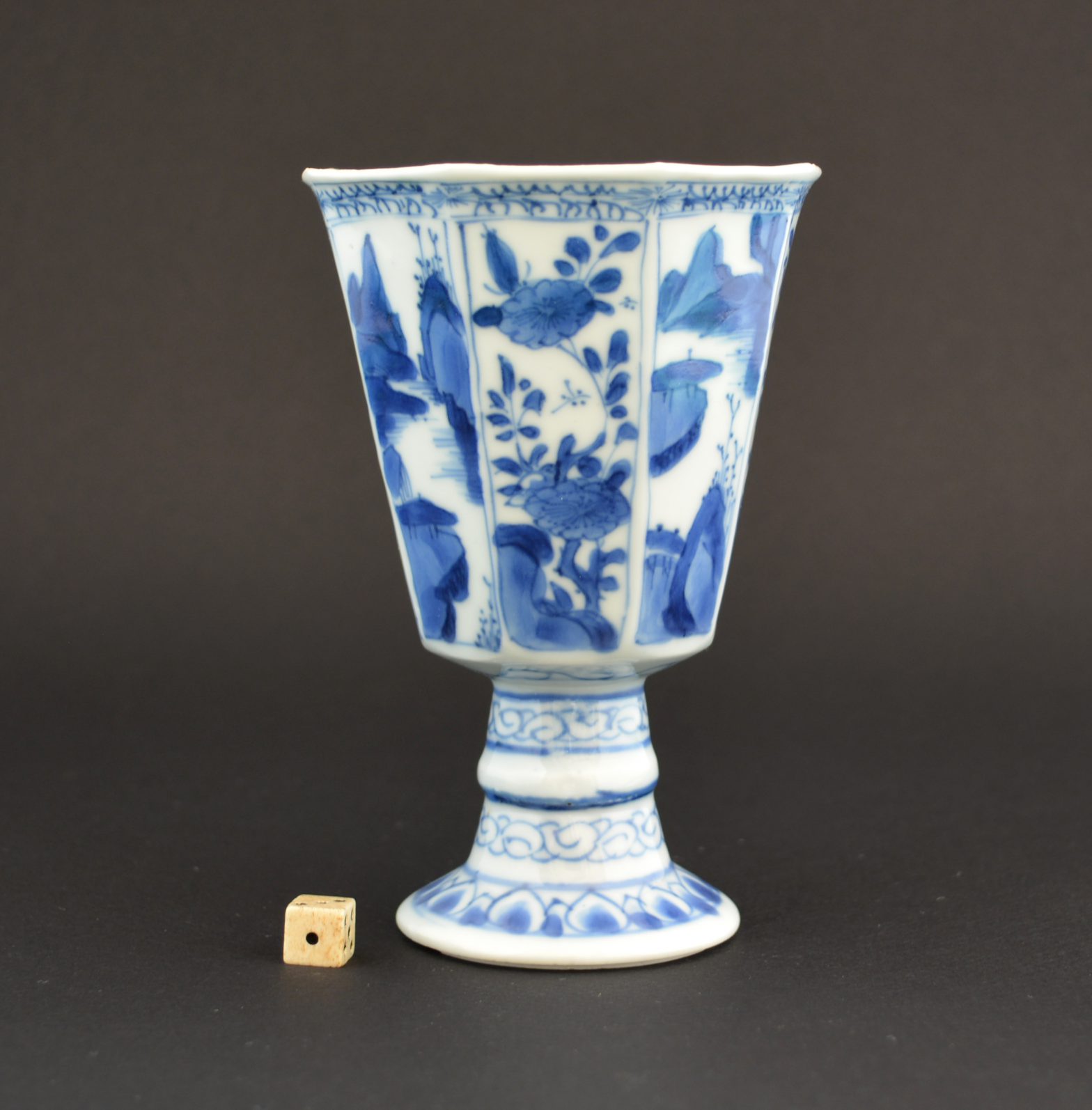 A Kangxi Porcelain Goblet of European Form, Kangxi Period c.1695-1715. This Octagonal Blue and White Porcelain Goblet is Based on a European Glass. The Decoration of the Thinly Potted Cup Consist of Alternating Landscapes with Flower Panels. The Knopped Stem is Supported by a Flaring Foot.SOLD Condition In excellent condition, a few minute glaze frits. Size Height : 12 cm (4 3/4 inches) Provenance The Gustav Leonhardt Collection from The Bartolotti House Amsterdam. Gustav Leonhardt (1928-2012) was born in `s-Graveland, North Holland and studied organ and harpsichord from 1947 to 1950 with Eduard Müller at the Schola Cantorum Basiliensis in Basel. In 1950, he made his debut as a harpsichordist in Vienna, where he studied musicology. He was professor of harpsichord at the Academy of Music from 1952 to 1955 and at the Amsterdam Conservatory from 1954. He was also a church organist. Leonhardt performed and conducted a variety of solo, chamber, orchestral, operatic, and choral music from the Renaissance, Baroque and Classical periods. The many composers whose music he recorded as a harpsichordist, organist, clavichordist, fortepianist, chamber musician or conductor. See Wikipedia for more details. Stock number 24299